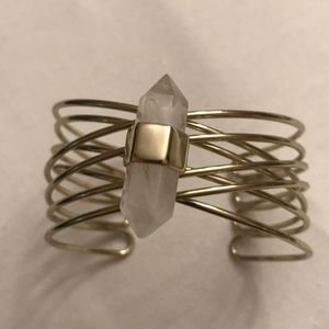 Gold bracelet with stone on top